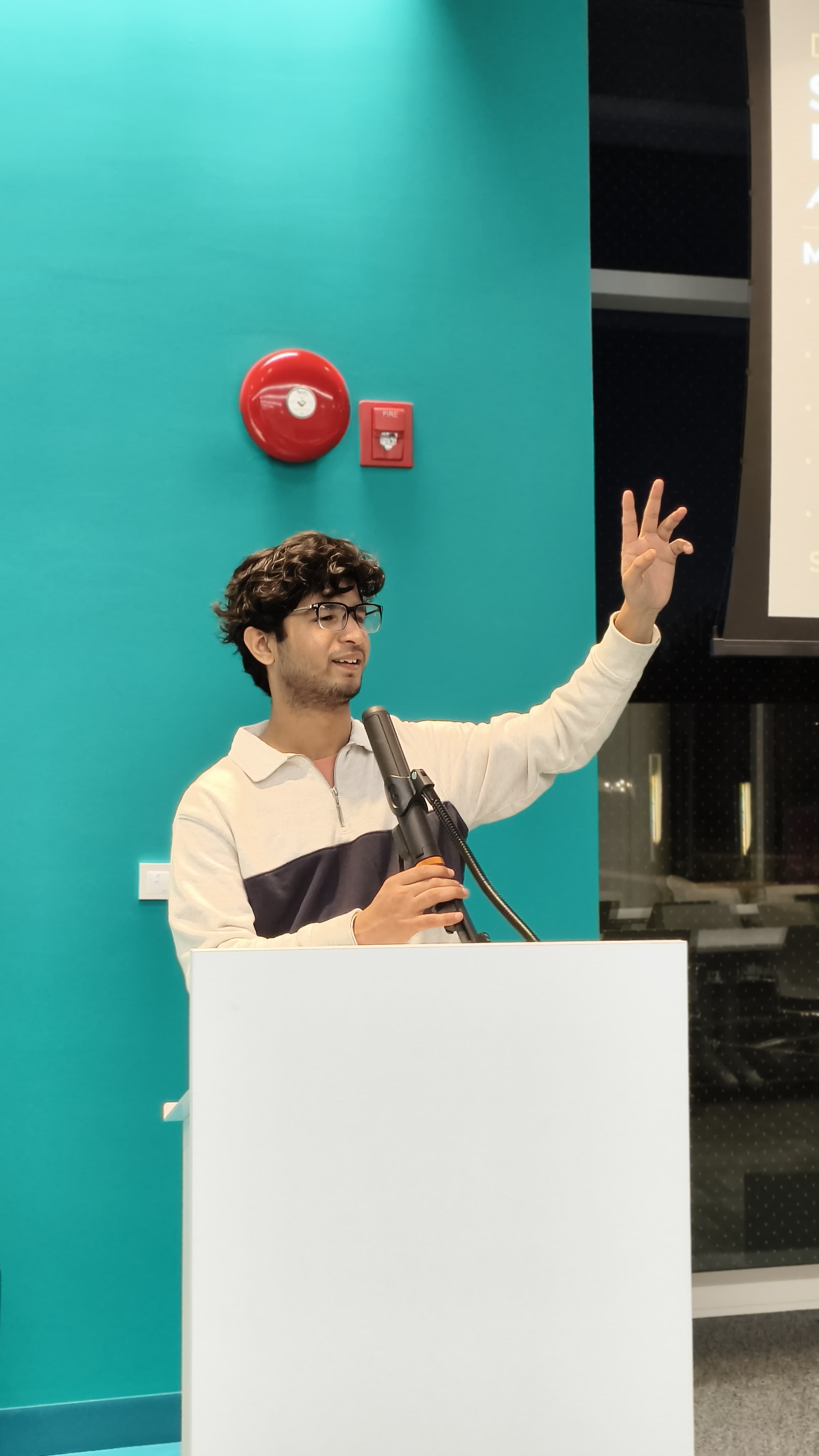 Keshav speaking at a microphone